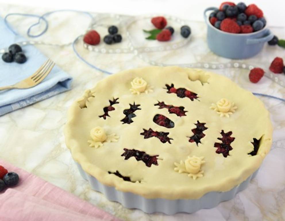 *** Variante 2: Lochmuster Pie *** Für unsere "Lochmuster Pie" wurde aus ausgerolltem Teig zunächst, wie gewohnt, der große Teigkreis für den Deckel ausgeschnitten. Anschließend wurde dieser - wie beim Scherenschnitt! - zweimal gefalten, bis nur noch ein gefaltetes Kreisviertel übrig ist. Entlang der beiden langen Kanten haben wir nun mit einem gezackten Ausstecher kleine Löcher ausgestochen. Danach wird das Kreisviertel wieder zu einem ganzen, runden Kreis aufgeklappt und über die vorbereitete Pie-Form gelegt. Aus Teigresten haben wir zusätzlich Blätter ausgestochen, zarte Röschen gedreht und auf die Pie gesetzt. *** Variante 2: Lochmuster Pie *** Für unsere "Lochmuster Pie" wurde aus ausgerolltem Teig zunächst, wie gewohnt, der große Teigkreis für den Deckel ausgeschnitten. Anschließend wurde dieser - wie beim Scherenschnitt! - zweimal gefalten, bis nur noch ein gefaltetes Kreisviertel übrig ist. Entlang der beiden langen Kanten haben wir nun mit einem gezackten Ausstecher kleine Löcher ausgestochen. Danach wird das Kreisviertel wieder zu einem ganzen, runden Kreis aufgeklappt und über die vorbereitete Pie-Form gelegt. Aus Teigresten haben wir zusätzlich Blätter ausgestochen, zarte Röschen gedreht und auf die Pie gesetzt.