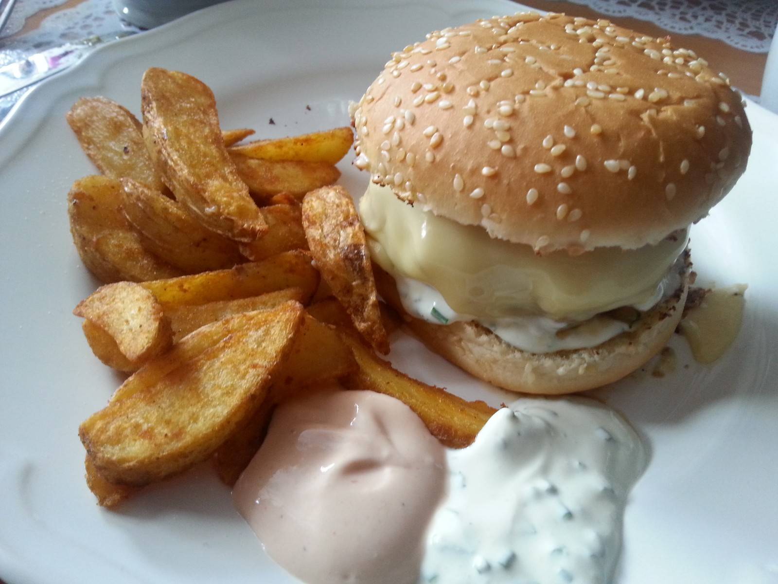 Cheeseburger mit karamelisierten Zwiebeln und zweierlei Soßen