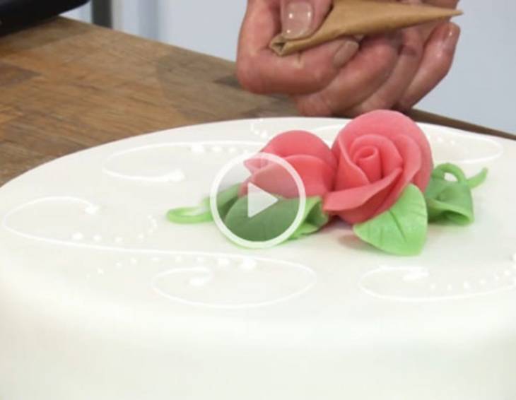 Torte mit Rosen und Spritzglasur verzieren