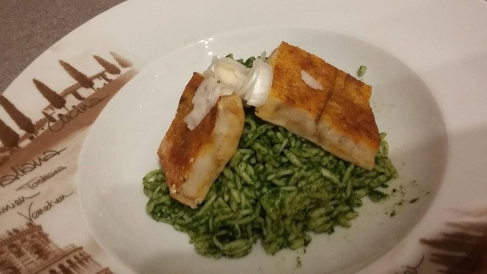 Feuriger Fisch auf Spinatnudeln